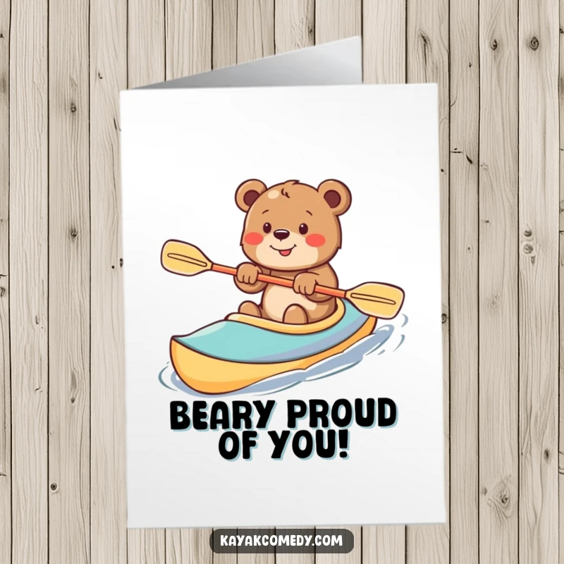 Funny Free Printable Congratulations Card: Smiling bear cub enthusiastically paddling a colorful kayak, celebrating achievement.