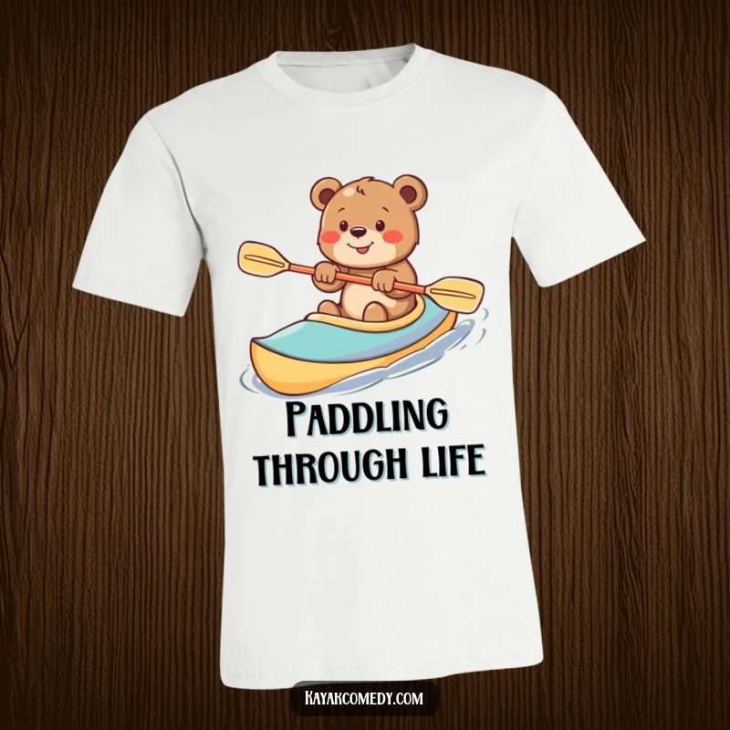 Funny T-Shirt: An excited bear cub paddles a bright kayak with gusto, embodying pure adventurous spirit. Perfect gift.